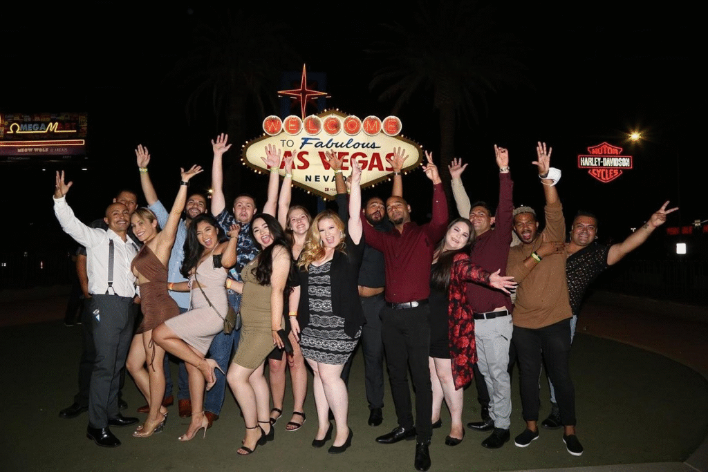 Group in front of the iconic Las Vegas sign during party bus las vegas crawl experience