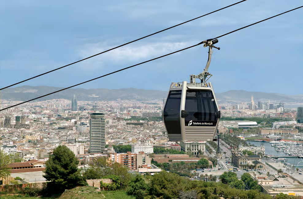 Friends admiring medieval Barcelona architecture before ascending Montjuic cable car for panoramic views