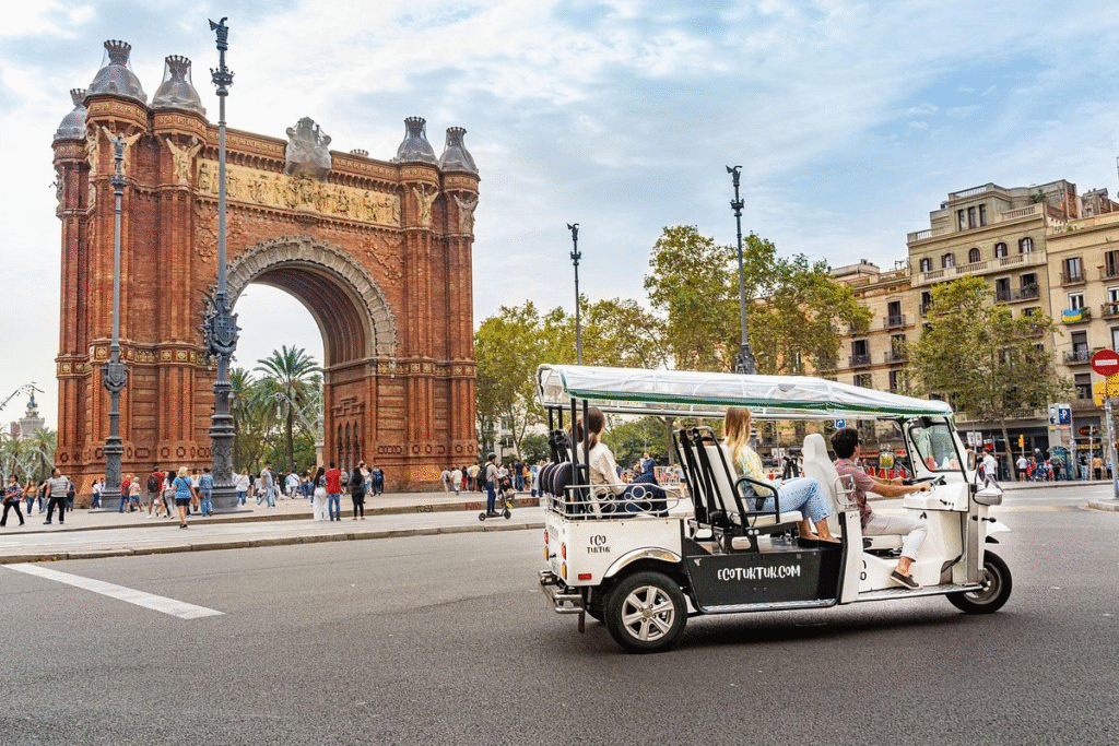 Solo traveler on Barcelona express tuk tuk tour with guide at upper city viewpoint
