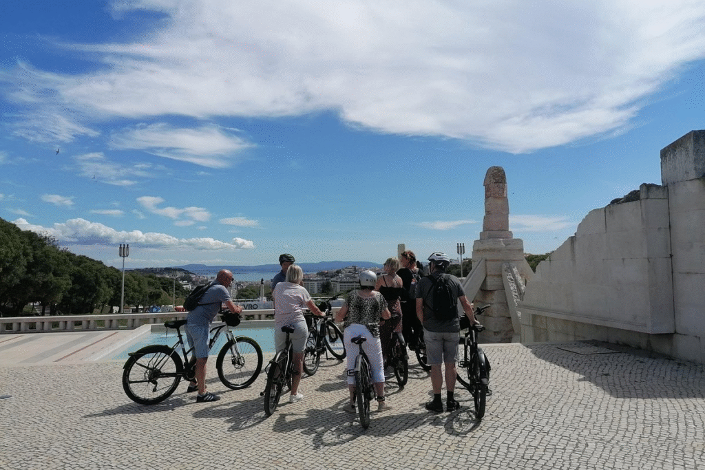 Bike tour participants riding through central Lisbon's historic neighborhoods and monuments