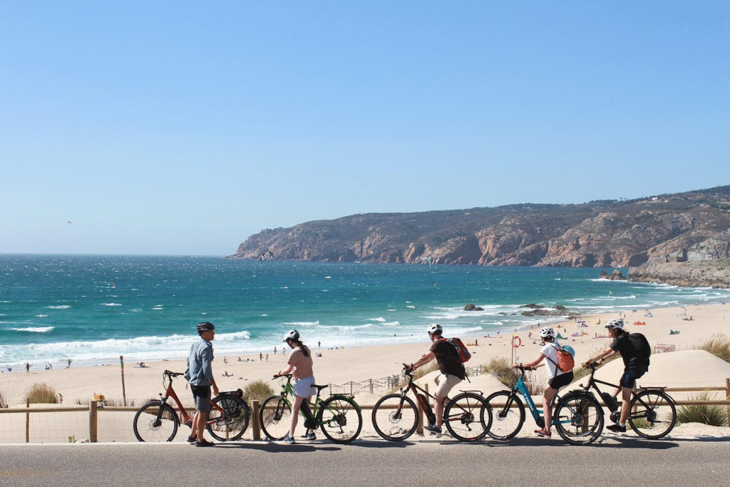 Electric bike riders cycling through Sintra-Cascais Natural Park on a full-day Lisbon bike tour