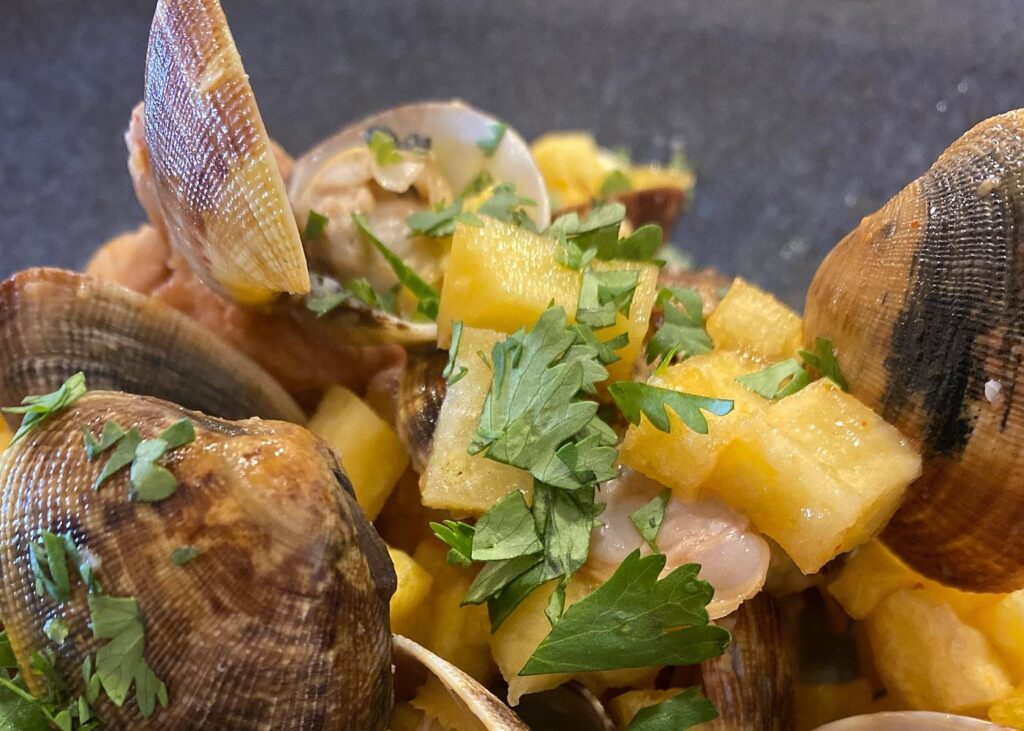 Fresh seafood, colorful fruit and herbs displayed at a Lisbon cooking class preparation table