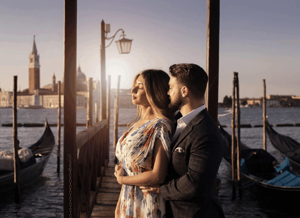 Romantic couple photographed during golden hour private gondola ride venice experience