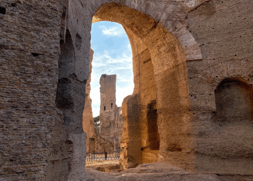 baths of caracalla tickets image showing towering brick arches and ancient ruins inside the Roman bath complex
