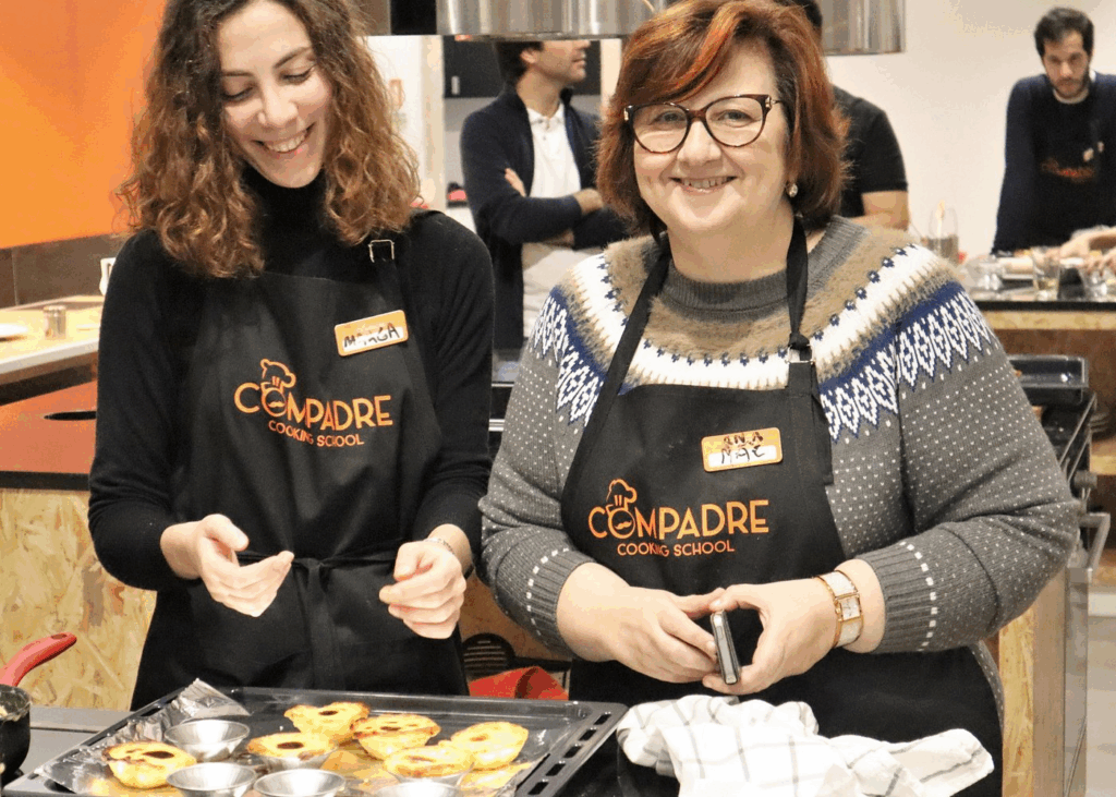 Morning participants folding dough during pastel de nata cooking class Lisbon experience