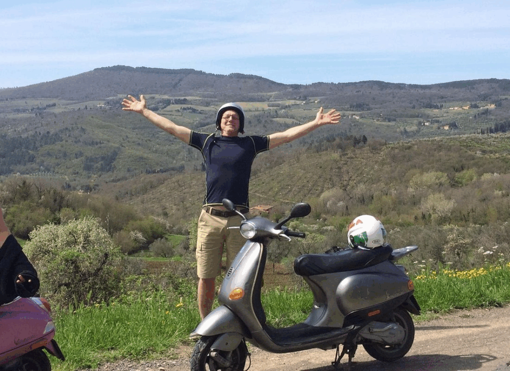 Travelers on vespa tour Tuscany arriving at organic farm winery in Chianti Rufina for lunch