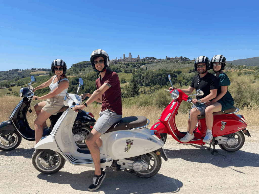 Couples enjoying Tuscany Vespa tours near Barberino Tavarnelle with olive groves along country roads