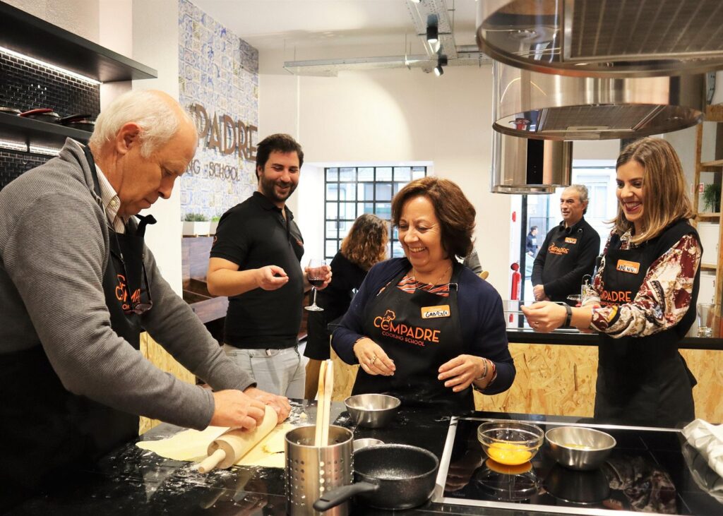 Families enjoying hands-on pastel de nata cooking class Lisbon in bright culinary studio