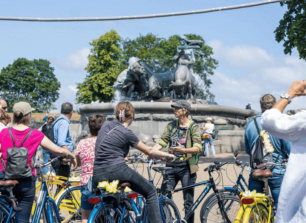 Tour group stopping at the Gefion Fountain during a copenhagen bike tour in central Copenhagen.