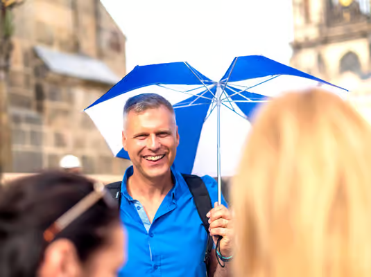 Morning walking tour crossing Charles Bridge whilst guide shares legends about the famous statues lining the route