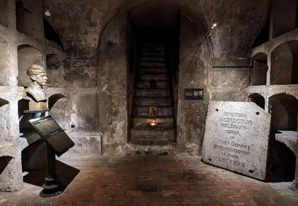 Small group learning about WWII resistance history under the Cathedral of Saints Cyril and Methodius in Prague