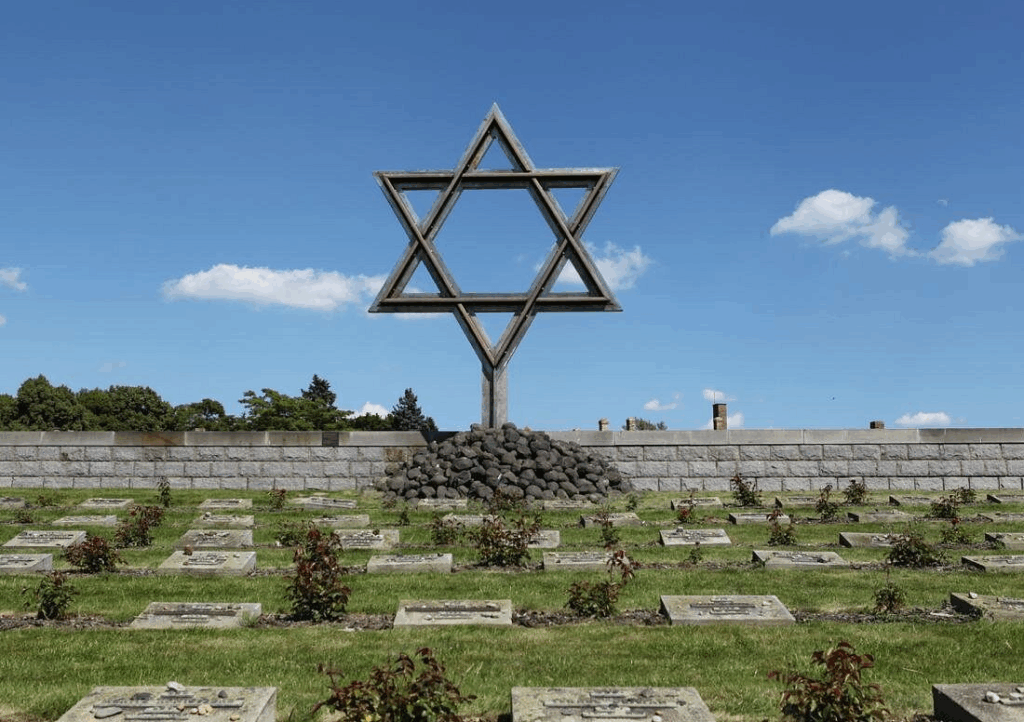 Day trips from Prague with visitors at Terezín Memorial's Jewish Cemetery during morning tour