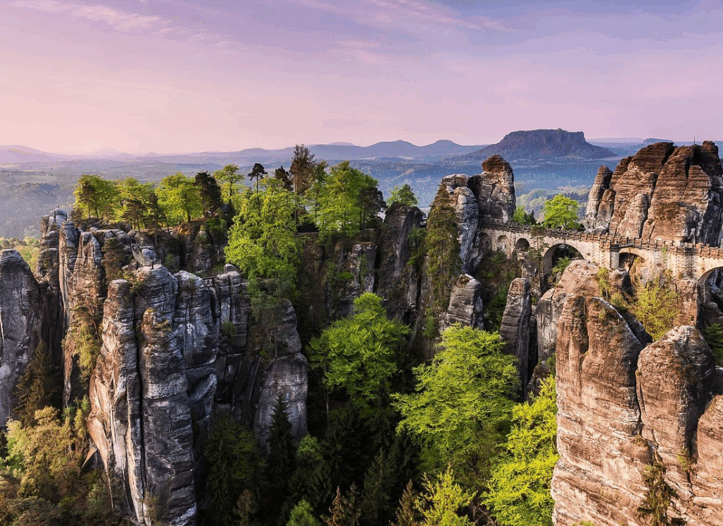 Day trips from Prague to the Bastei Bridge, with sweeping views of sandstone cliffs and forested landscapes