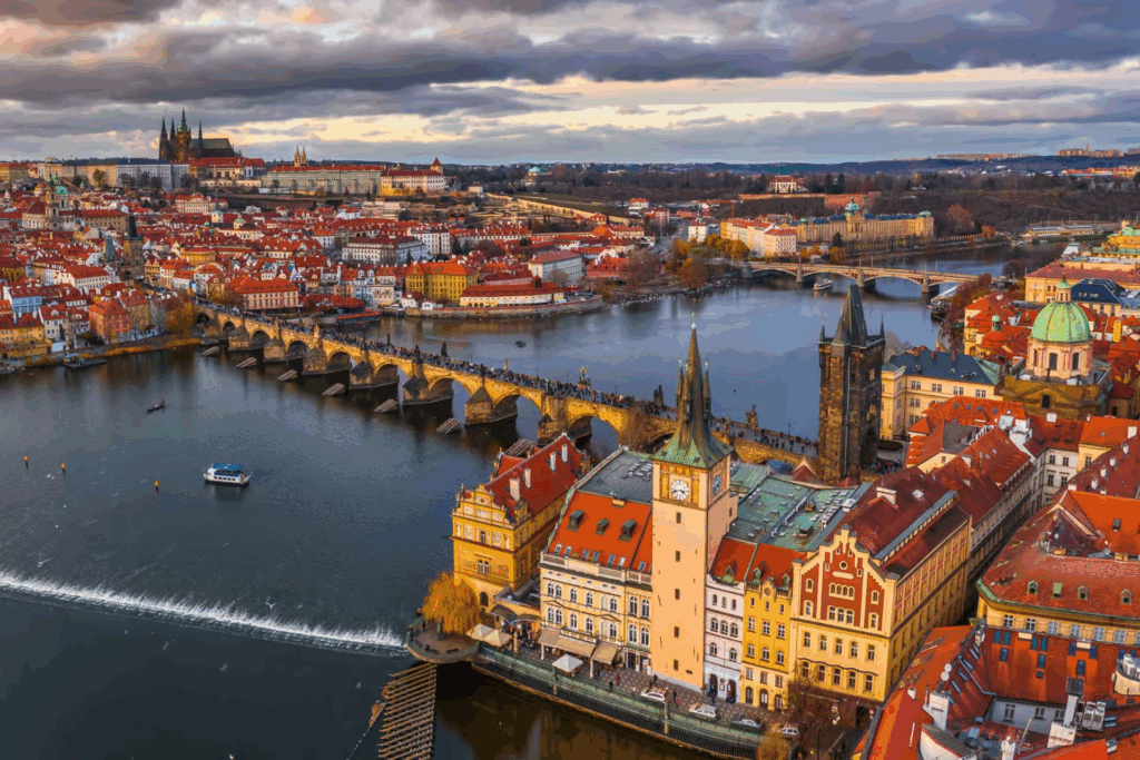 Prague Jewish Quarter walking tour with panoramic aerial view of the Vltava River, Charles Bridge, Old Town rooftops, and Prague Castle in the distance