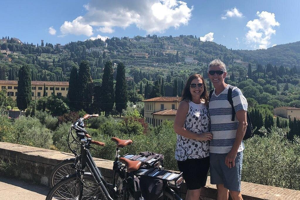 City bike tours in Florence featuring cyclists riding near historic architecture and Tuscan surroundings