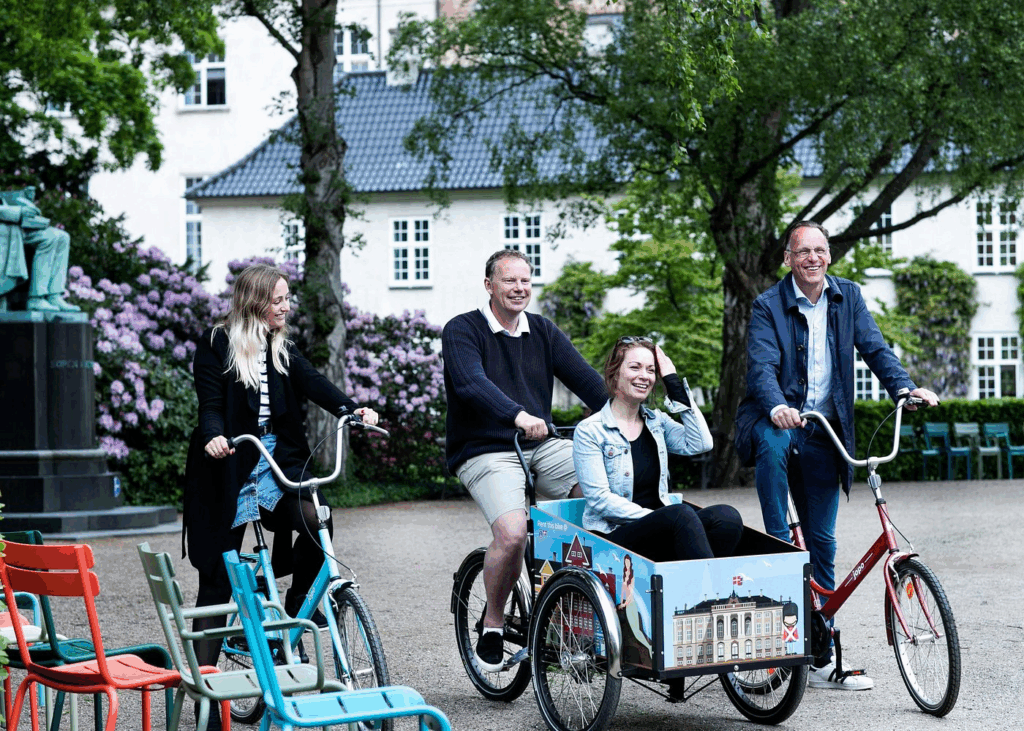 City bike tours in Copenhagen showing cyclists riding on protected urban bike lanes and waterfront routes