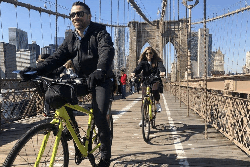 City bike tours in New York City featuring cyclists riding waterfront greenways and urban bike lanes